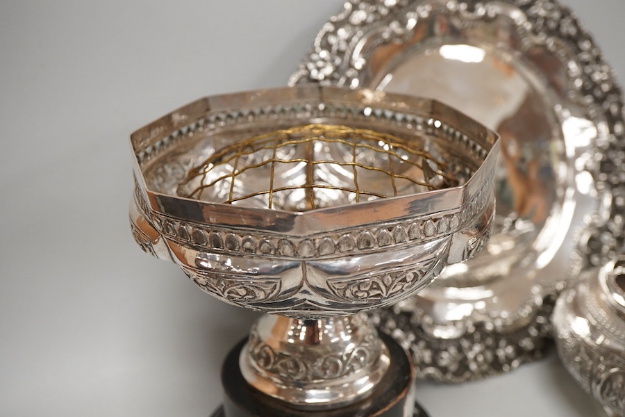 Two Indian white metal rose bowls, one octagonal with stand, diameter 12.5cm, together with a small white metal stand, with foliate border.